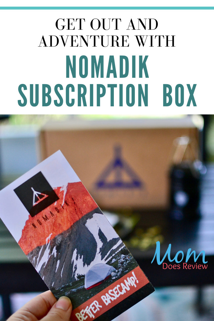 Nomadik subscription box with pamphlet and text overlay